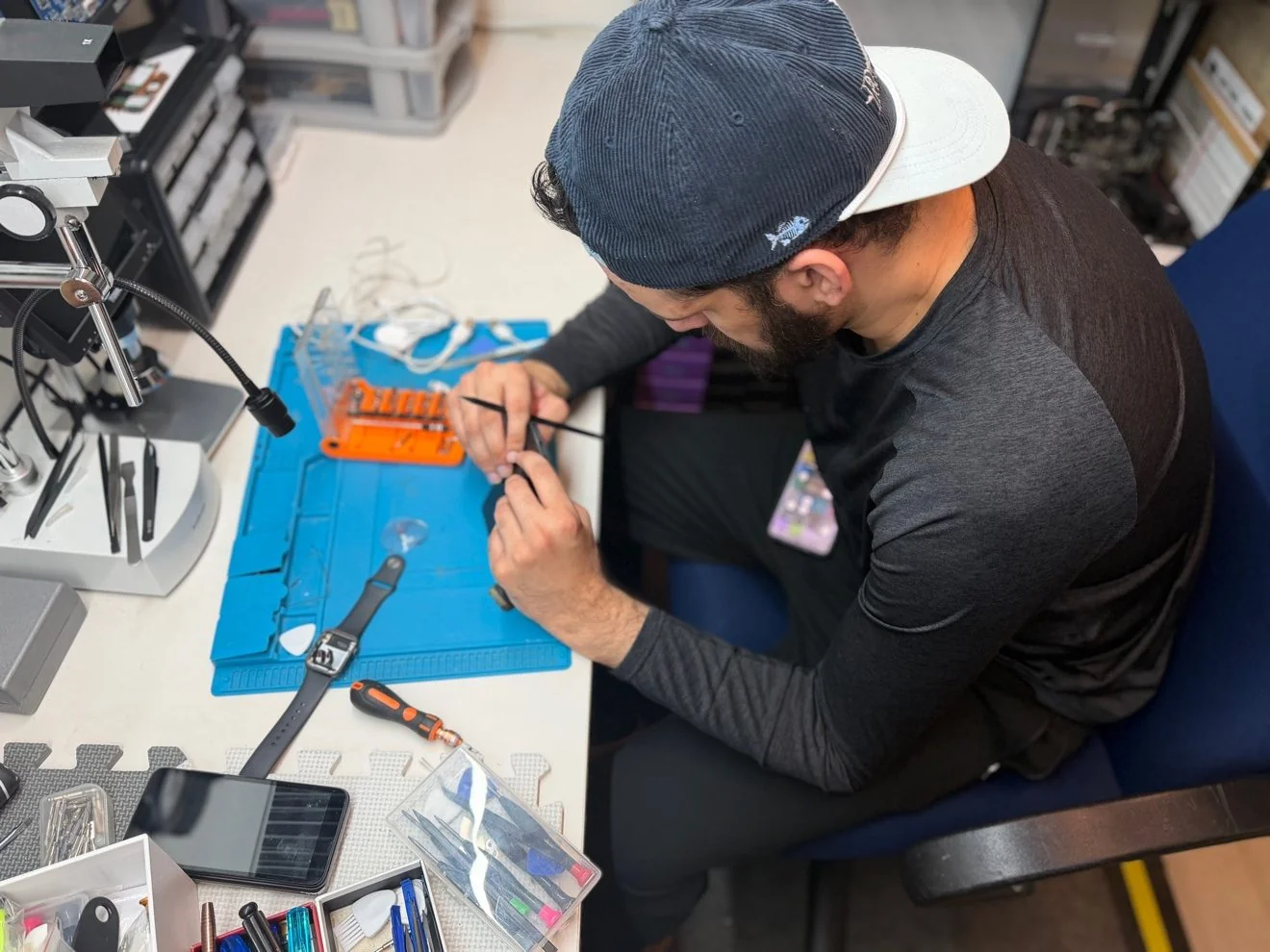 AZ Tech Services technician performing precision computer repair at the work bench in Ashburn